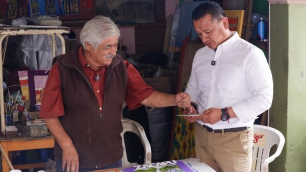Carlos Torres Piña caminando entre ciudadanos en una comunidad rural de Michoacán, en interacción cercana y sin cámaras visibles