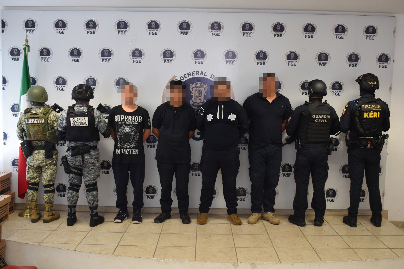 Logos oficiales superpuestos: Fiscalía General de Michoacán, Guardia Civil, Secretaría de la Defensa Nacional y Guardia Nacional, sobre fondo azul oscuro
