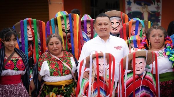 Carlos Torres Piña conversando con comuneros en Urandén, Michoacán, frente a un camino recién construido con apoyo de